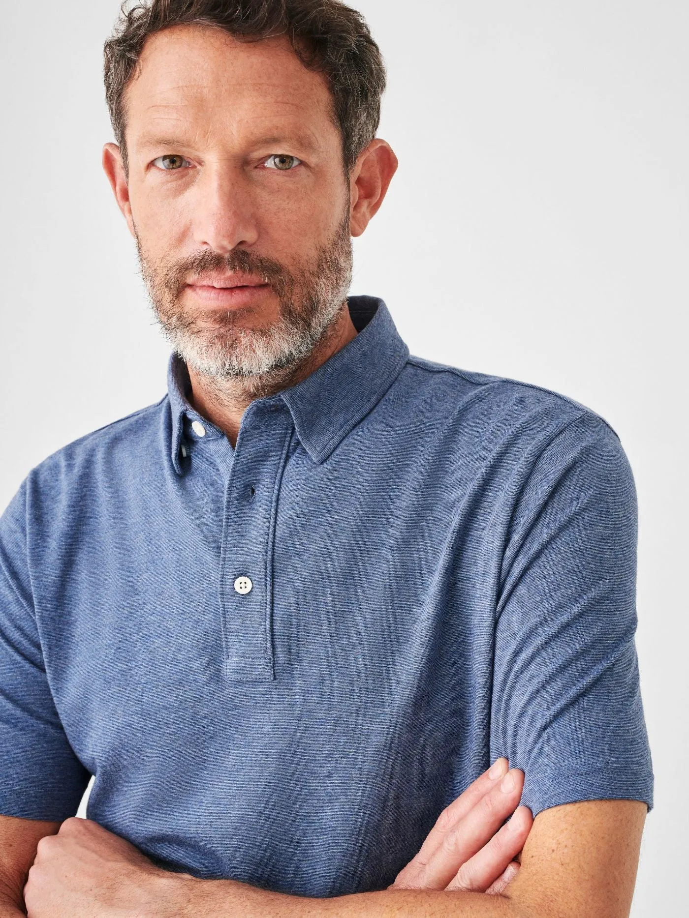 Faherty Short Sleeve Movement Polo in Sea Navy Melange